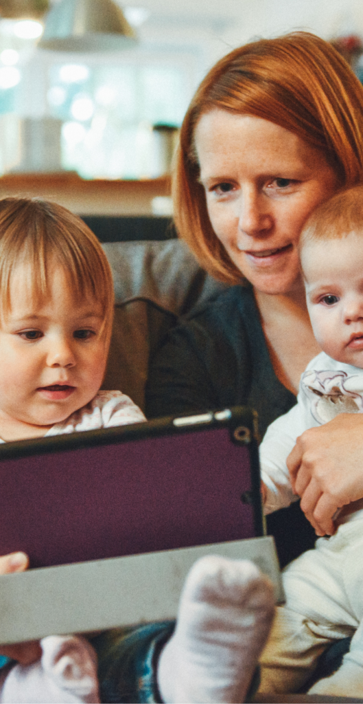 alexander-dummer-uh-xs-fiz-tk-unsplash@3x A young family watching something on a tablet